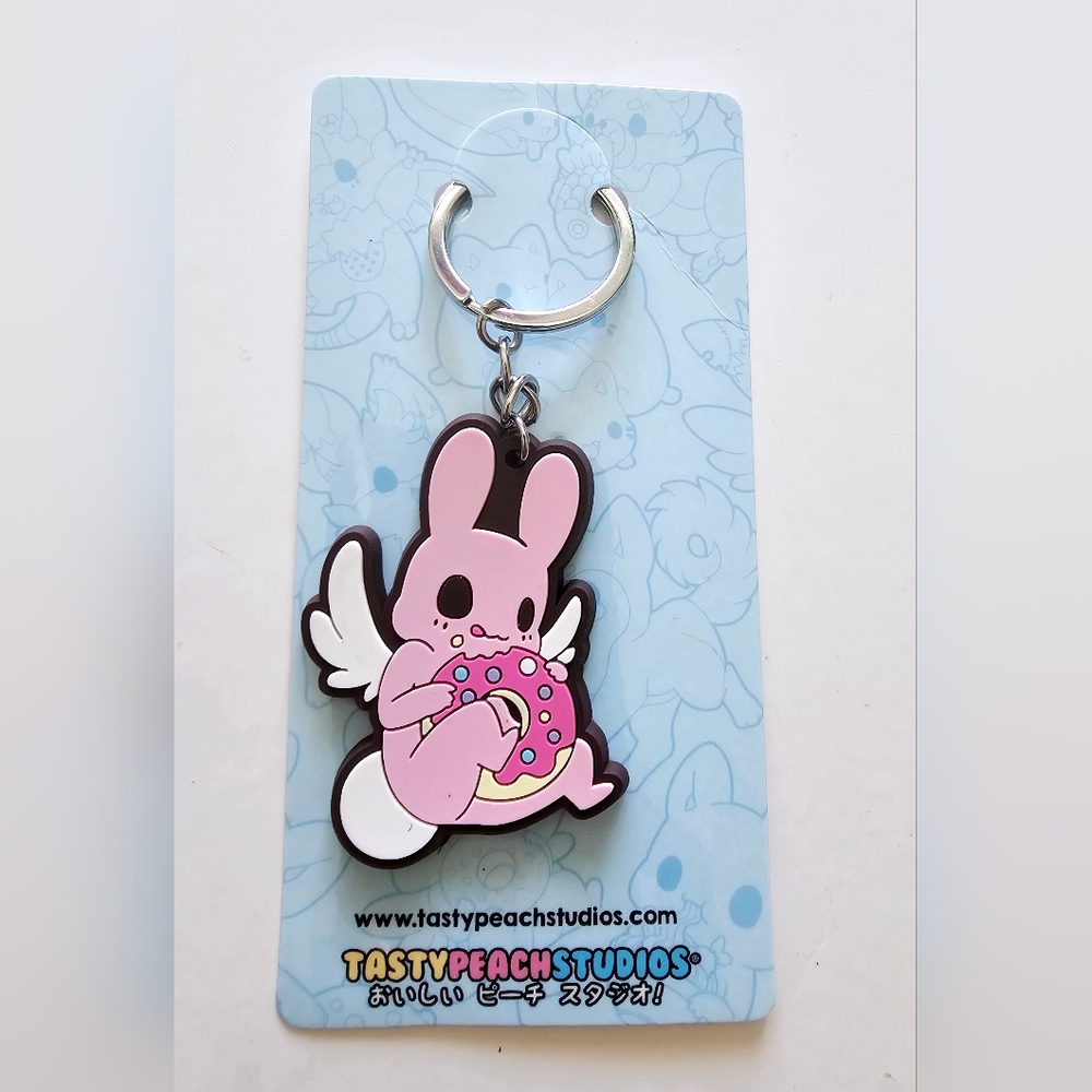 NWT Tastypeach studios cute keychain of plushie eating a donut keychain